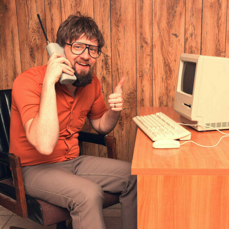 1980s computer nerd with retro cell phone